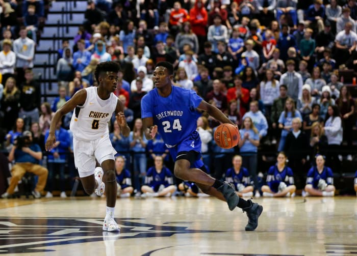 Greenwood's Aminu Mohammed drives downcourt as Kickapoo's Anton Brookshire chases him during the Gold Division championship game in the Blue and Gold Tournament on Monday, Dec. 30, 2019.